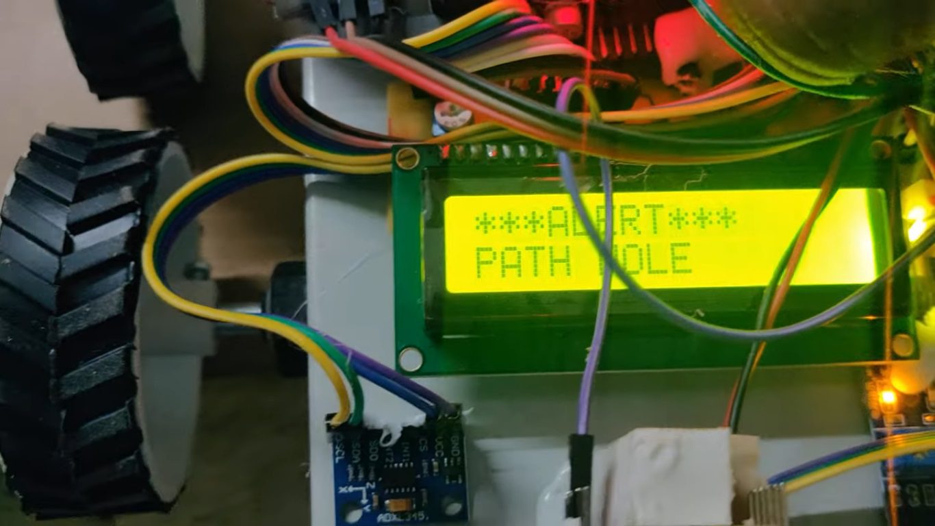 HVS-4738. Automatic Detection and Notification of Path Holes, Humps to aid Drivers with Image Capture, SMS